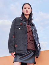 a lady in black denim jacket with mini leather skirt